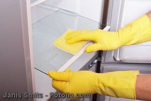 Hands cleaning refrigerator.