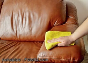 hand wiping couch brown