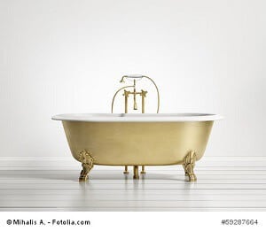 Isolated gold bronze classic bathtub on white wood floor