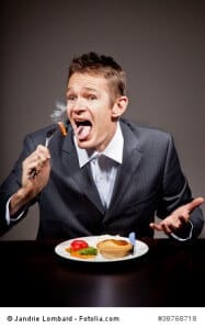 MAn burning his mouth on hot food