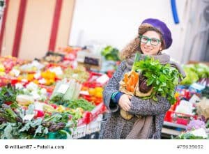 Young Woman Buying Vegetables at Local Market
